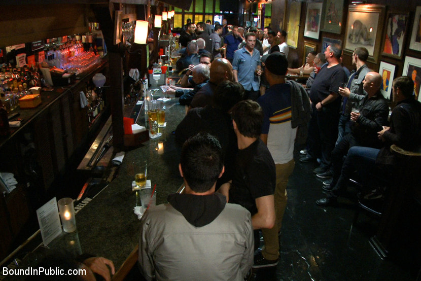 Naked ripped stud gets humiliated and used in a crowded public bar.