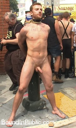 Stud in a metal cage is fucked by horny bar patrons