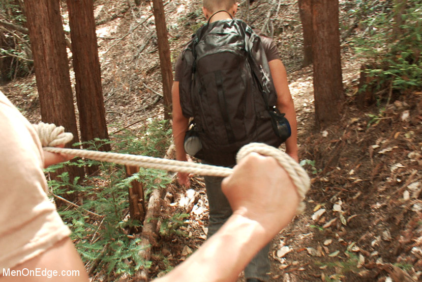 Captured straight jock gets his tight ass violated in the deep woods
